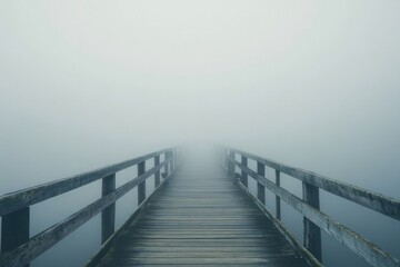 Fototapeta premium Mysterious foggy pier disappearing into the mist tranquil coastal setting serene nature scene wide-angle view concept of isolation