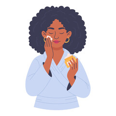 Woman in bathrobe applying face cream isolated on white background, skin care concept