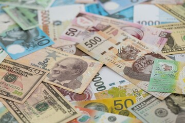 Big amount of money bills of different currencies and countries. Assortment background of international cash in big pile close up
