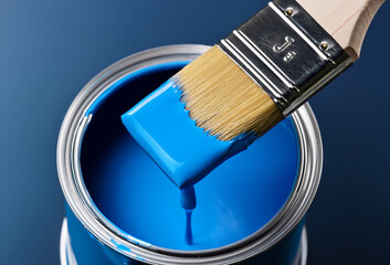 A close-up view of a paintbrush dipped in vibrant blue paint, ready for a fresh coat of color.