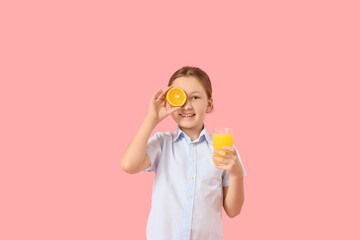 Cute little girl with orange and glass of juice on pink background