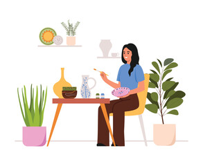 Fototapeta premium Vector illustration of a girl in a pottery workshop.Cartoon scene of a girl sitting on a chair ,a table with plates,jugs, holding a brush, painting a plate, flower pots isolated on a white background.
