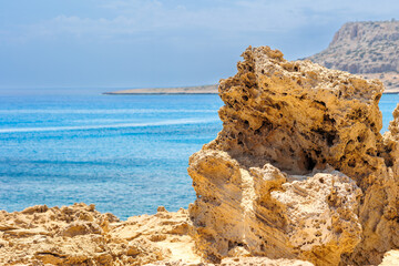 Rocky Cyprus Coastline with Boats on Clear Blue Sea, Scenic coastal view in Cyprus featuring...