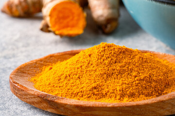 Turmeric with its magnificent orange color on a vintage white background