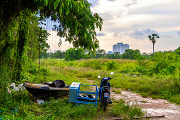 Motorbike boat vehicles left in the tropical nature jungle in Thailand.