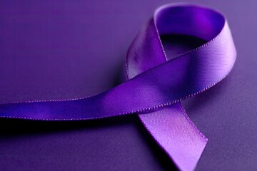 A closeup of a purple ribbon against a matching purple background