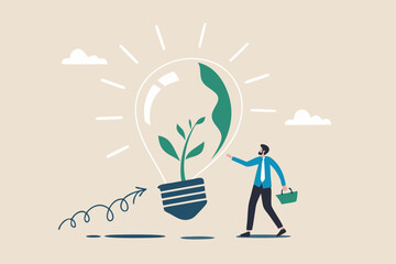 Ecology and sustainable business, green idea or protection against world climate change, environmental care concept, smart businessman watering seedling sprout growing inside green lightbulb idea.