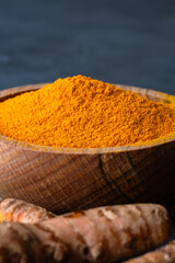 Turmeric with its magnificent orange color on a vintage black background