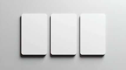 Three blank white rectangular cards arranged side by side on a light gray surface.