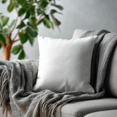 A cozy seating area showcasing a white cushion on a gray sofa with a patterned blanket. Complemented by lush green plants and natural wooden furniture, creating a serene and inviting ambiance.