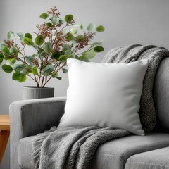 A cozy seating area showcasing a white cushion on a gray sofa with a patterned blanket. Complemented by lush green plants and natural wooden furniture, creating a serene and inviting ambiance.
