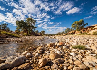 A classic arid landscape with a rocky river bed and blue sky in the afternoon sun, this photograph captures the architecture of Australia's Outback in the northwest. 