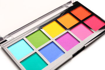 Palette of colorful eyeshadows on white background, closeup