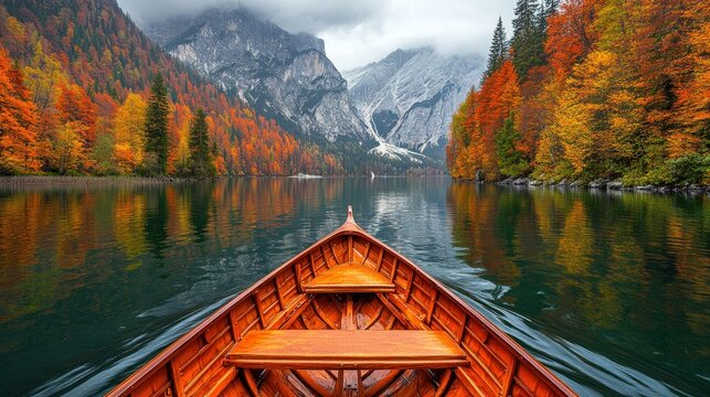 Serene autumn lake view from a wooden rowboat, reflecting colorful trees and majestic mountains