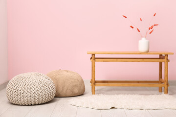 Interior of modern living room with coffee table and poufs