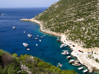 Limnionas Port on Zakynthos island with boats in a deep blue bay, surrounded by green coastline and...
