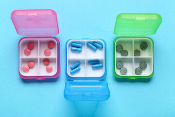 Containers with different pills on blue background