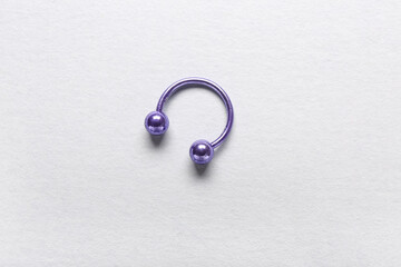 Purple  circular barbell for piercing on white background
