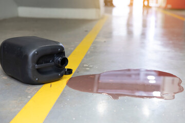 Car oil leak on concrete garage floor with yellow parking line