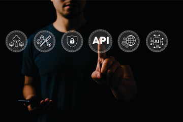 Man Interacting with Virtual API Interface on Touchscreen – Futuristic Technology Concept with Cybersecurity, AI, Cloud Computing, and Data Network Icons on Black Background