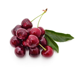 Bunch of ripe cherries on green leaves.