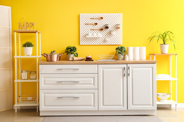 Interior of stylish kitchen with white counter and peg board
