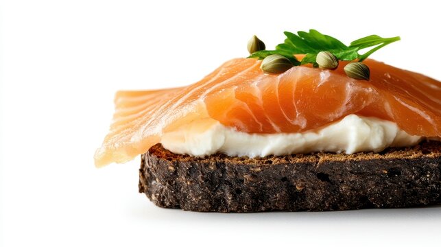 An appetizing close-up of an open-faced salmon sandwich, featuring fresh salmon, creamy topping, and garnished with herbs on a piece of dark rye bread that looks delicious.