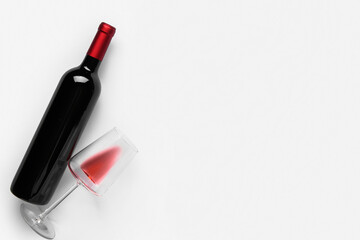 Bottle and glass of red wine on white background. Top view