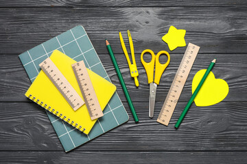 Set of school supplies on dark wooden background