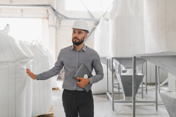 Engineer inspecting flour production in food processing plant