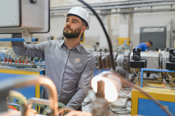 Engineer operating machinery in window and door factory