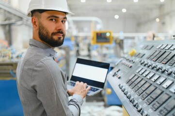Industrial engineer working with laptop in a factory