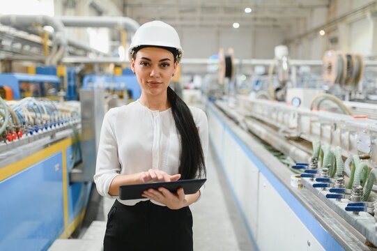 Female engineer using digital tablet in pvc and aluminum window factory