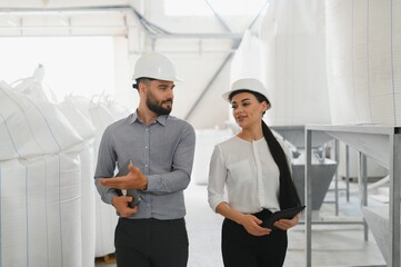 Engineers walking and discussing in a modern factory