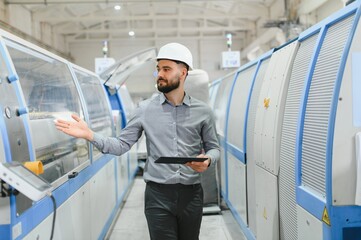Supervisor walking and controlling production line in modern factory