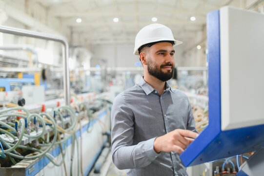 Industrial engineer operating machinery in modern factory