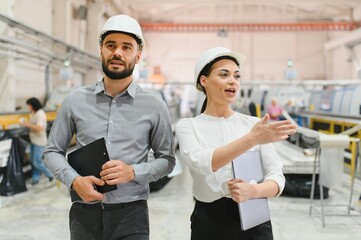 Engineers walking and discussing in a modern factory