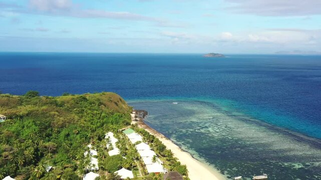 Tourist resort on Tokoriki island in Fiji pacific coral reefs &ndash; aerial 4k landing to beach.
