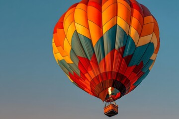 Fototapeta premium Colorful Hot Air Balloon Soaring Against Clear Blue Sky at Sunset.