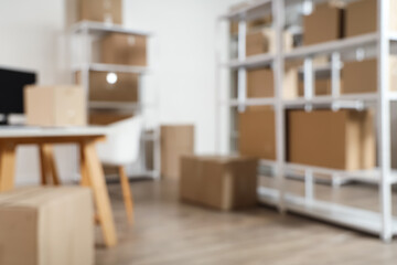 Blurred view of warehouse with shelf units and cardboard boxes