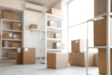 Blurred view of warehouse with shelf units and cardboard boxes