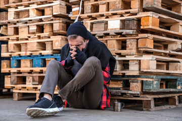 Frozen homeless man sitting on street