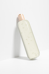 Clear cosmetic plastic bottle with wooden disk top flip cap mockup, flat disk cap round packaging, modern skincare container, cylindrical shape squeeze bottle, cylinder liquid shompoo bottle