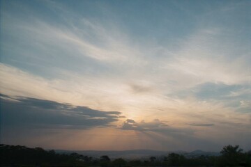 Fototapeta premium The view of the sea and mountains, flowers, beautiful clouds, and the sunlight is very beautiful.