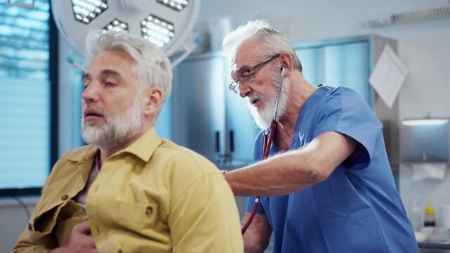 Doctor examining patient, listening to breathing with stethoscope.