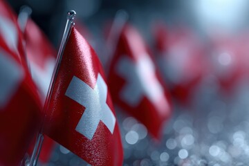 Multiple Swiss flags on silver stands with a bokeh background