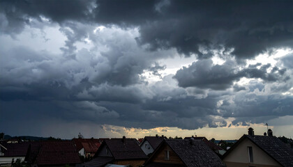 thick black clouds above the houses of the villagers