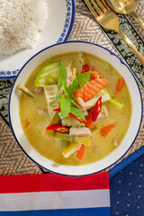 Zesty Thai green curry dances vibrantly beside jasmine rice, evoking Songkran festivities and Thai Lunar New Year culinary traditions