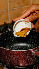 Golden curry blooms into speckled pot, culinary alchemy unfolds, Diwali dinner, bold South Asian spice ritual, taste festival