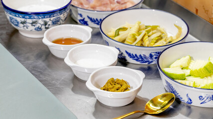 White porcelain bowls adorned with cobalt blue patterns hold exotic pickled treasures, evoking Lunar New Year culinary enchantment